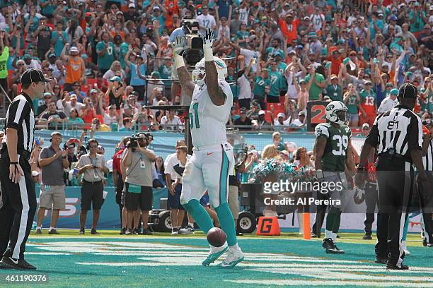 Right Guard Mike Pouncey celebrates when Running Back Daniel Thomas of the Miami Dolphins scores a touchdown against the New York Jets at Sun Life...