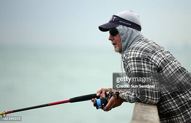 Joe Thuma, of Ft. Lauderdale, waits for a strike at Anglin's Fishing Pier in Lauderdale-by-the-Sea, Tuesday, Jan 7, 2013. Fishermen on the pier were...