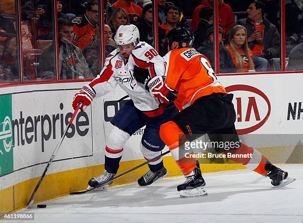 Nicklas Grossmann of the Philadelphia Flyers rides Marcus Johansson of the Washington Capitals into the boards during the first period at the Wells...
