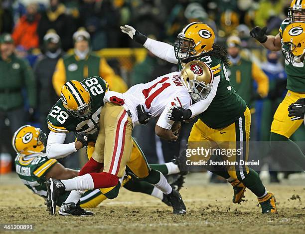 Quinton Patton of the San Fransico 49ers is tackled by Sean Richardson and Josh Boyd of the Green Bay Packers during an NFC Wild Card Playoff game at...