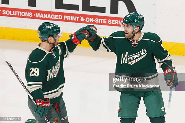 Jason Zucker and Jason Pominville of the Minnesota Wild celebrate after scoring a goal against the Chicago Blackhawks during the game on January 8,...