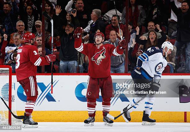 Shane Doan of the Arizona Coyotes celebrates alongside Keith Yandle after Doan scored a second-period power-play goal against Adam Pardy and the...