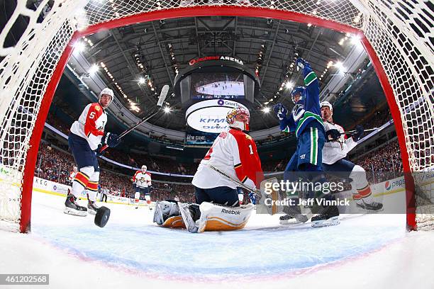 Alexandre Burrows of the Vancouver Canucks celebrates a goal by Daniel Sedin as Willie Mitchell, Aaron Ekblad and Roberto Luongo of the Florida...
