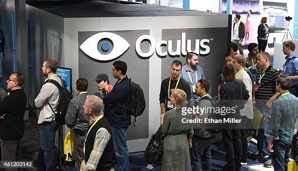 Attendees wait in line at the Oculus VR booth to try the company's immersive, virtual reality headsets at the 2015 International CES at the Las Vegas...