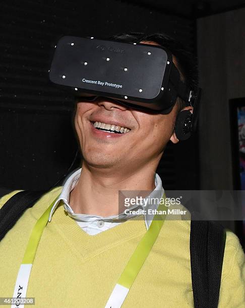 Bin Li of China tries out the Oculus VR Crescent Bay Headset prototype at the 2015 International CES at the Las Vegas Convention Center on January 8,...