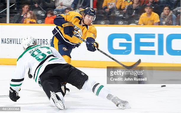 Colin Wilson of the Nashville Predators takes a slapshot against Ales Hemsky of the Dallas Stars during an NHL game at Bridgestone Arena on January...