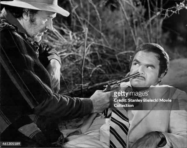 Actor Gene Hackman holding a gun to Burt Reynolds face, in a scene from the movie 'Lucky Lady', 1975.