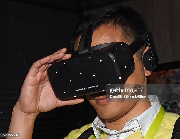 Bin Li of China tries out the Oculus VR Crescent Bay Headset prototype at the 2015 International CES at the Las Vegas Convention Center on January 8,...