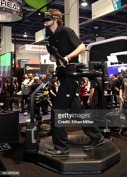 Jeremy Gaddis uses the Virtuix Omni, an omni-directional treadmill virtual reality gaming system with Oculus Rift, at the 2015 International CES at...