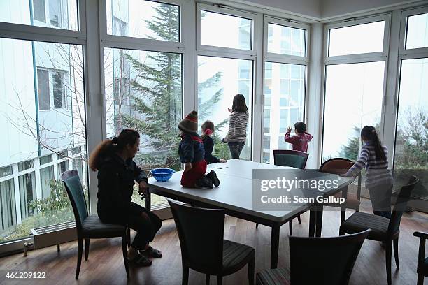 Refugee children play in the dining room at the Spreehotel refugee center on January 8, 2015 in Bautzen, Germany. Approximately 200 refugees, many of...