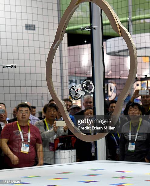 Attendees watch as a Parrot MiniDrone Jumping Sumo jumps through an obstacle at the 2015 International CES at the Las Vegas Convention Center on...