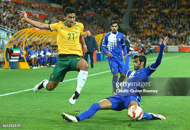 Massimo Luongo of Australia is tackled by Khaled Alqahtani of Kuwait during the 2015 Asian Cup match between the Australian Socceroos and Kuwait at...