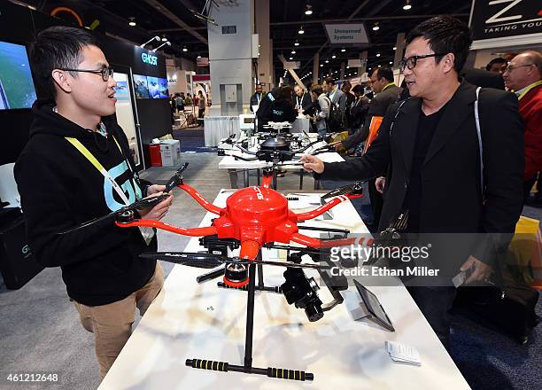 Guanglong Zeng of EHang Inc. Shows attendees the Skyway drone by EHang at the 2015 International CES at the Las Vegas Convention Center on January 8,...