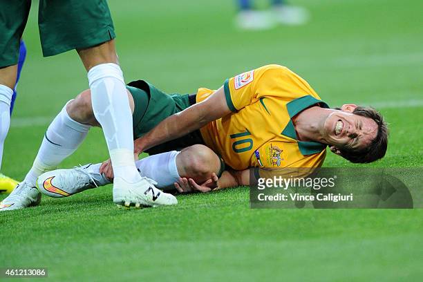 Robbie Kruse of Australia reacts after being tackled during the 2015 Asian Cup match between the Australian Socceroos and Kuwait at AAMI Park on...
