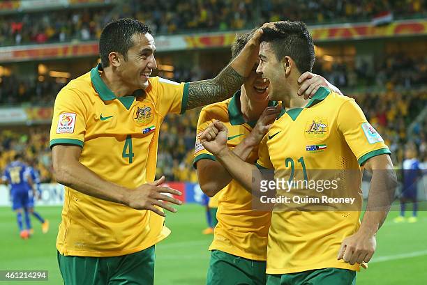 Massimo Luongo of Australia is congratulated by Tim Cahill and Robbie Kruse after scoring a goal during the 2015 Asian Cup match between the...