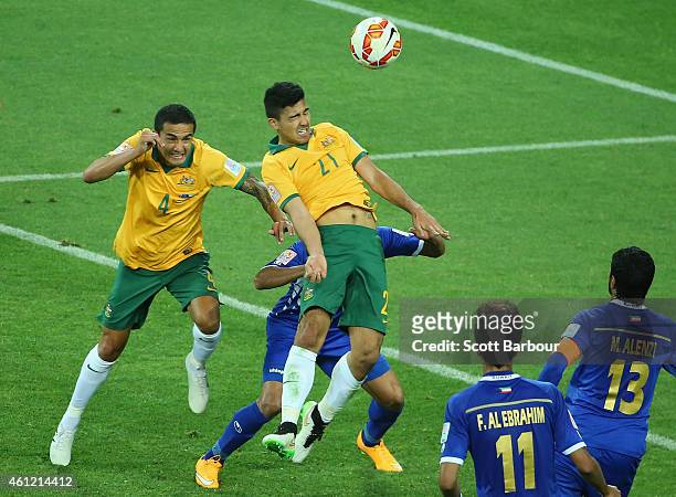 Massimo Luongo of the Socceroo heads the ball to score a goal as Tim Cahill looks on during the 2015 Asian Cup match between the Australian Socceroos...
