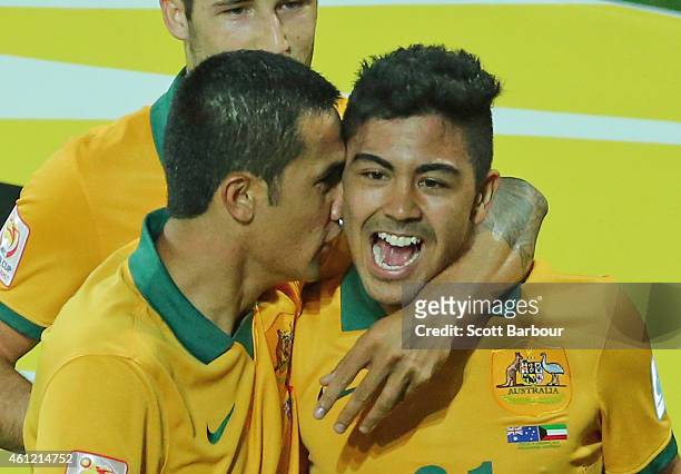 Massimo Luongo of the Socceroos is congratulated by Tim Cahill and his teammates after scoring a goal during the 2015 Asian Cup match between the...