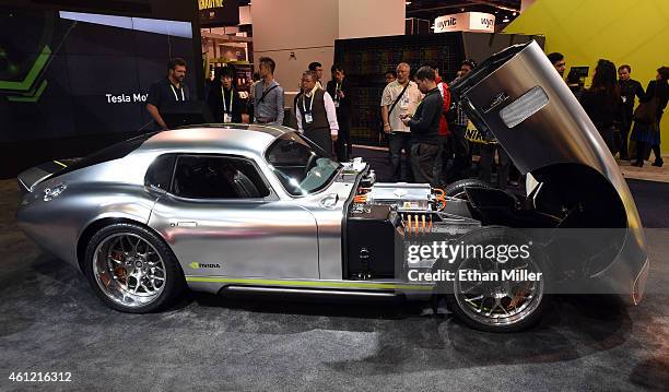 Attendees look at a Renovo Coupe production prototype vehicle powered by the Nvidia Tegra system on a chip at the 2015 International CES at the Las...