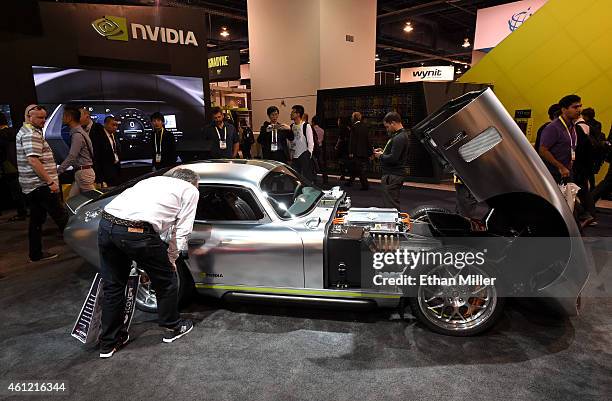 Attendees look at a Renovo Coupe production prototype vehicle powered by the Nvidia Tegra system on a chip at the 2015 International CES at the Las...