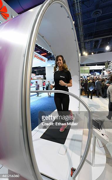 Nikki Obra runs on a treadmill while wearing Parrot Zik Sport wireless in-ear sport headphones at the 2015 International CES at the Las Vegas...