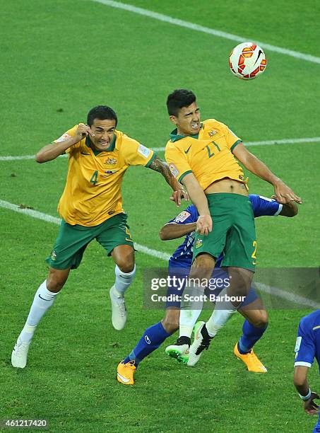 Massimo Luongo of the Socceroo heads the ball to score a goal as Tim Cahill looks on during the 2015 Asian Cup match between the Australian Socceroos...