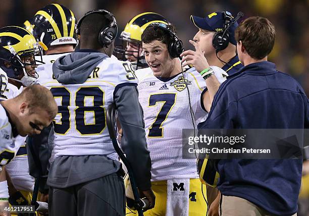 Quarterbacks Devin Gardner and Shane Morris of the Michigan Wolverines talk on the sideline during the Buffalo Wild Wings Bowl against the Kansas...