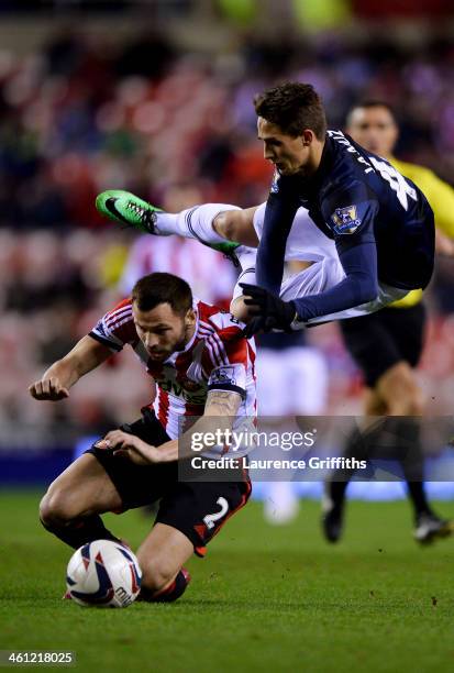 Adnan Januzaj of Manchester United is challenged by Phil Bardsley of Sunderland during the Capital One Cup Semi-Final, first leg match between...