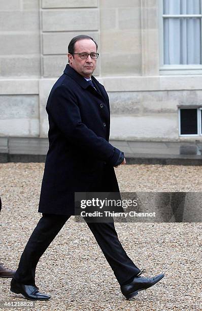 French President Francois Hollande leaves the presidential Elysee palace to hold a crisis meeting with French prefects at the Interior Ministry on...