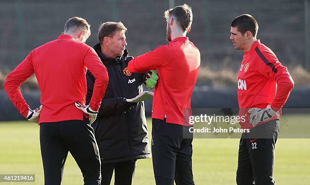 Anders Lindegaard, David de Gea and Victor Valdes of Manchester United speak to Goalkeeping Coach Frans Hoek during a first team training session at...