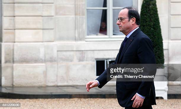 French President Francois Hollande returns to the presidential Elysee palace after holding a crisis meeting with French prefects at the Interior...