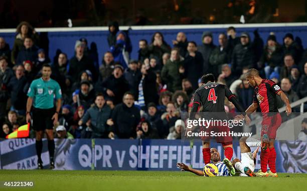 Wayne Routledge and Karl Henry of QPR come together during the Barclays Premier League match between Queens Park Rangers and Swansea City at Loftus...