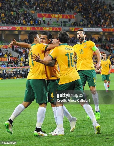 Tim Cahill of Australia celebrates with Massimo Luongo and Robbie Kruse after scoring his first goal in the first half during the 2015 Asian Cup...