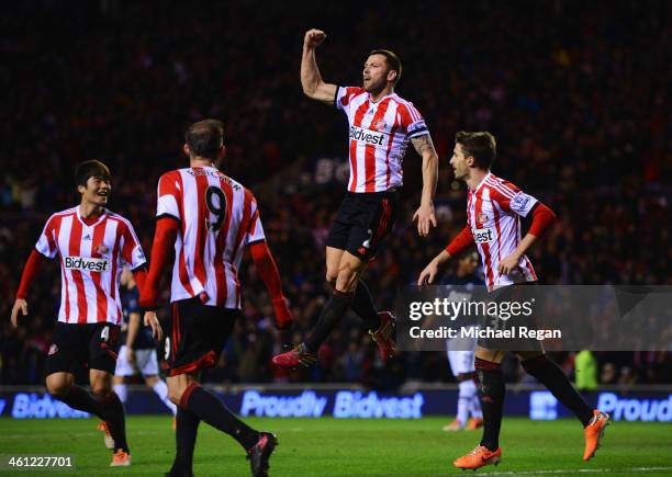 Phil Bardsley of Sunderland celebrates as Ryan Giggs of Manchester United scores an own goal during the Capital One Cup Semi-Final, first leg match...