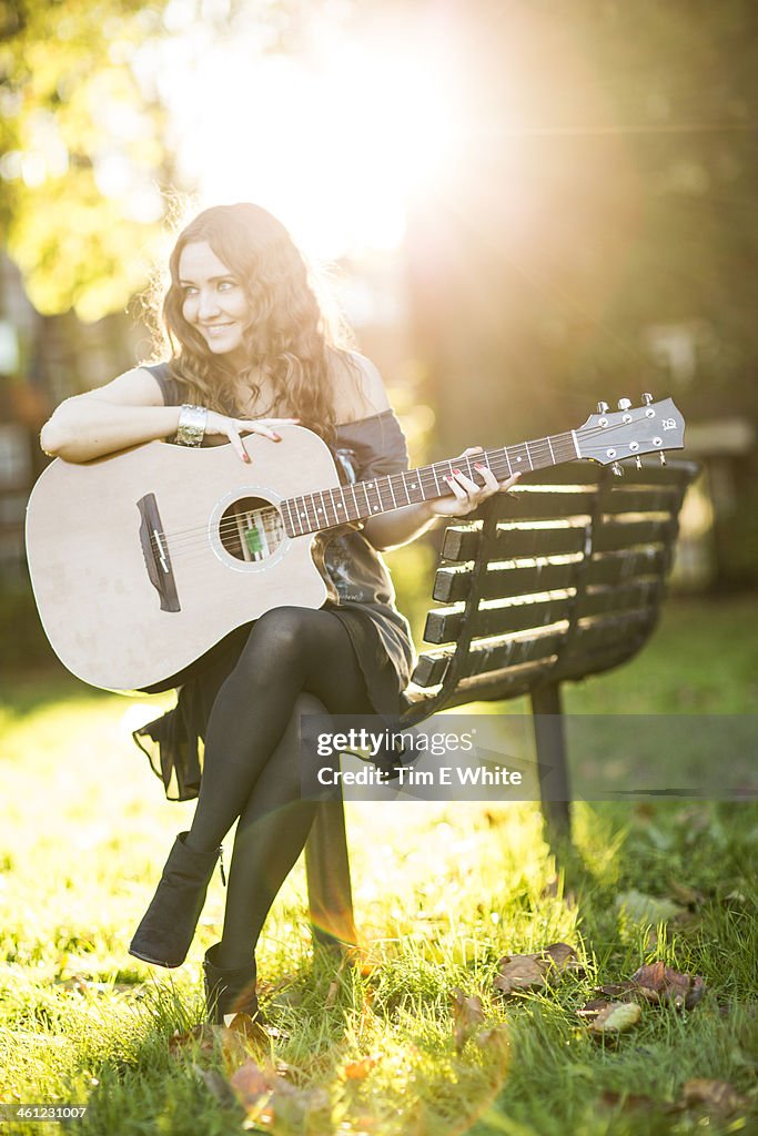 Woman with guitar, London, UK