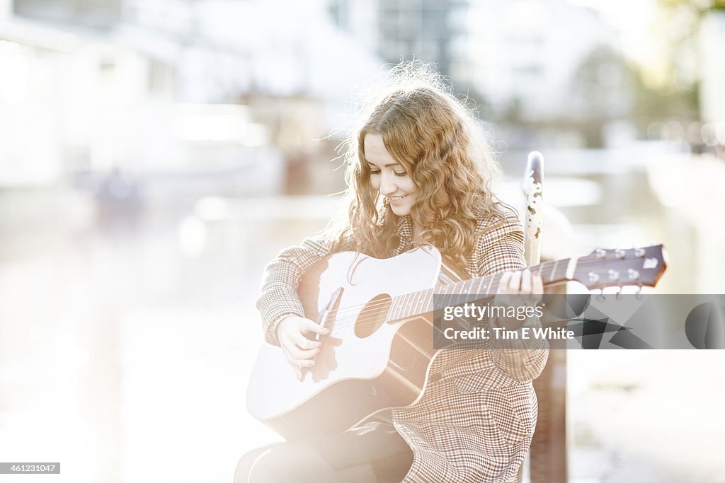 Woman with guitar, London, UK