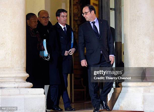 French President Francois Hollande talks with French Prime Minister Manuel Valls next to French Justice Minister Christiane Taubira and French...