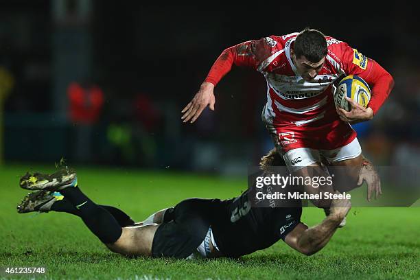 Jonny May of Gloucester is tackled by Marcelo Bosch of Saracens during the Aviva Premiership match between Gloucester Rugby and Saracens at Kingsholm...