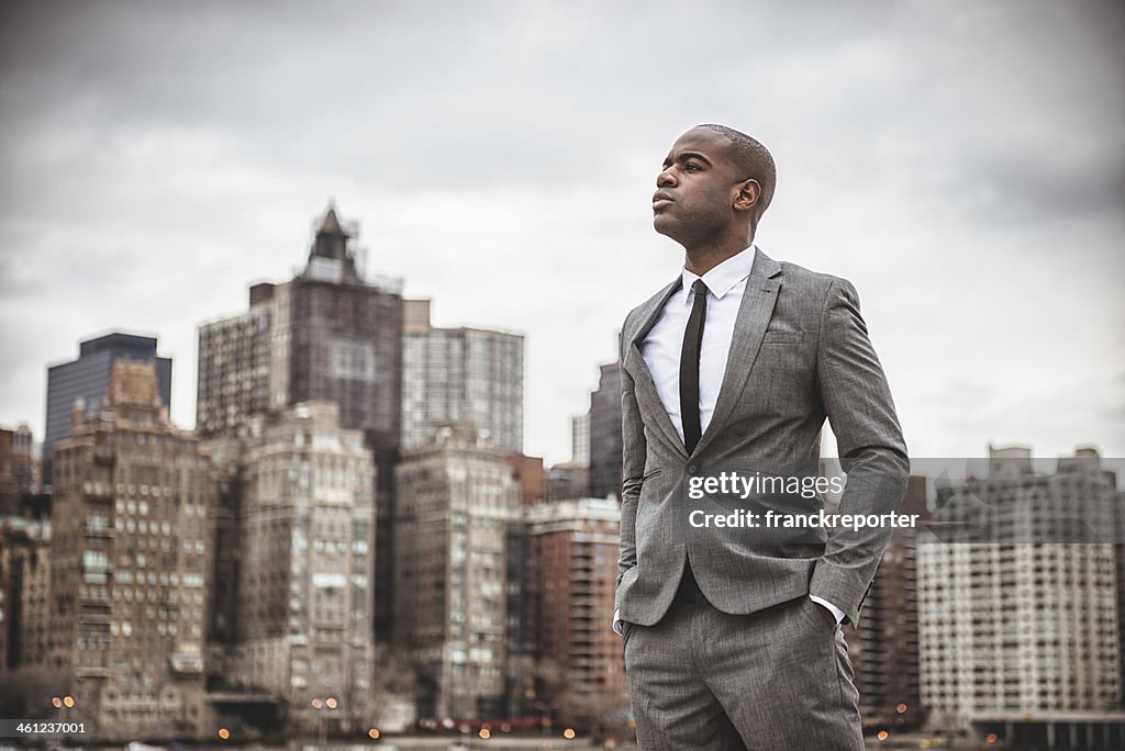 Successful business man looking away against the skyline