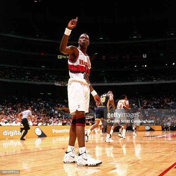Dikembe Mutombo of the Atlanta Hawks waves his finger after a block shot against the Indiana Pacers at the Georgia Dome on April 9, 1998 in Atlanta,...