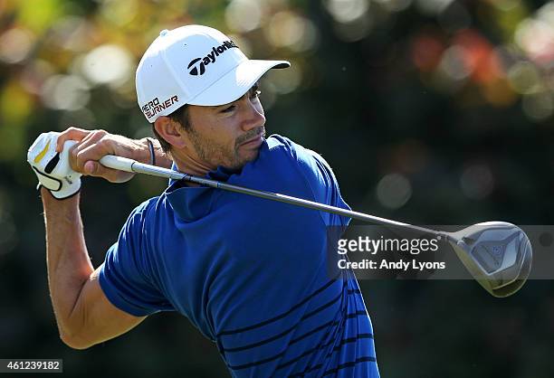 Camilo Villegas of Columbia plays his shot form the first tee during round one of the Hyundai Tournament of Champions at Plantation Course at Kapalua...