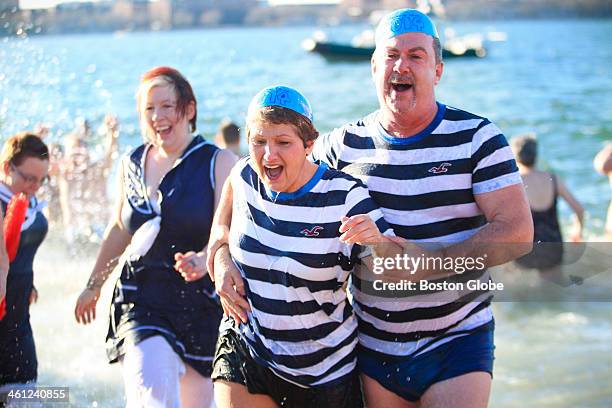 Hundreds of half-naked revelers stampeded into the Boston Harbor for the annual L Street Brownies New Years Day Swim on Wednesday, January 1, 2014.