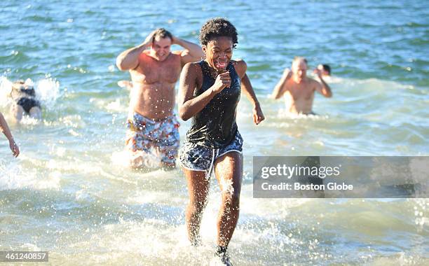 Hundreds of half-naked revelers stampeded into the Boston Harbor for the annual L Street Brownies New Years Day Swim on Wednesday, January 1, 2014.