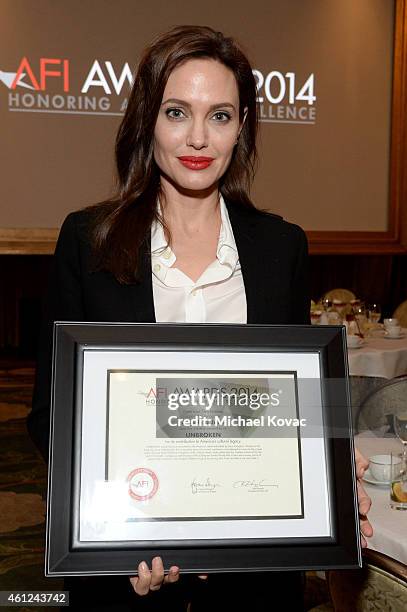 Actor-director Angelina Jolie poses with award during the 15th Annual AFI Awards Luncheon at Four Seasons Hotel Los Angeles at Beverly Hills on...