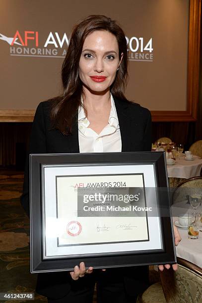 Actor-director Angelina Jolie poses with award during the 15th Annual AFI Awards Luncheon at Four Seasons Hotel Los Angeles at Beverly Hills on...