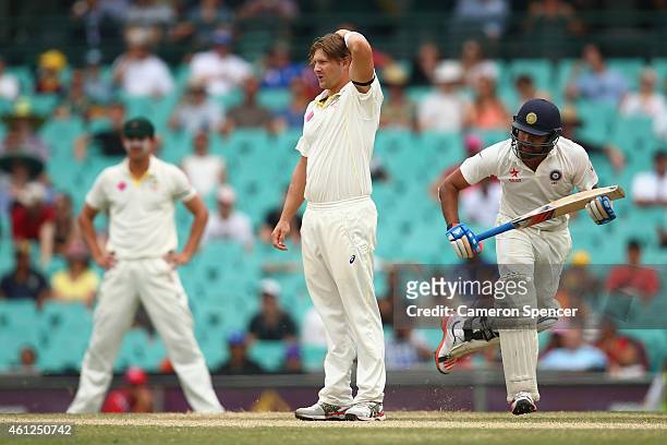 Shane Watson of Australia reacts to a shot off his delivery during day five of the Fourth Test match between Australia and India at Sydney Cricket...