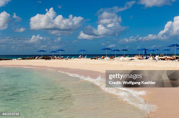 View of the white sand beach with tourists at the Hilton Barbados on Barbados, an island in the Caribbean.