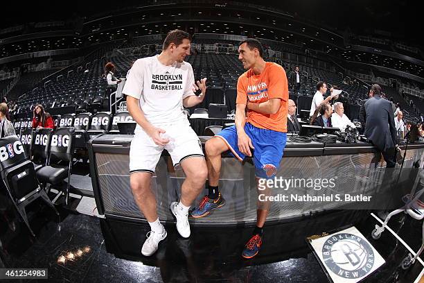 Mirza Teletovic of the Brooklyn Nets talks with Pablo Prigioni of the New York Knicks before a game during a game at Barclays Center on December 5,...