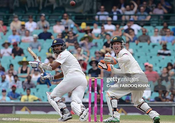 India's Murali Vijay plays a shot in front of Australia's wicketkeeper Brad Haddin during the final day of the fourth Test between Australia and...