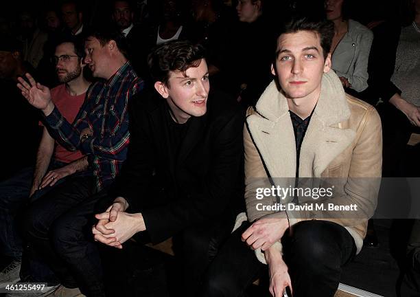 Beardyman, Adam Dewhurst, Teddy Edwards and George Craig sit in the front row during the Superdry AW14 catwalk event as part of London Collections:...