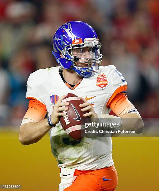 Quarterback Grant Hedrick of the Boise State Broncos drops back to pass during the against the Arizona Wildcats Vizio Fiesta Bowl at University of...